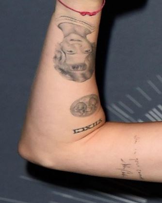 Tattoo of Loretta's face on Miley's hand